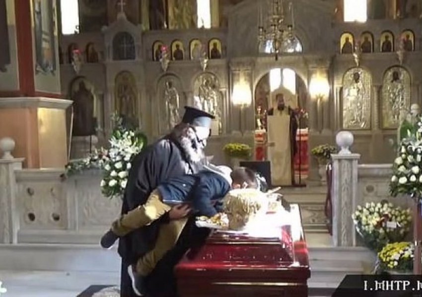 Skandaloze/ Prifti ngre lartë një fëmijë për ta puthur arkivolin e peshkopit që vdiq nga koronavirusi