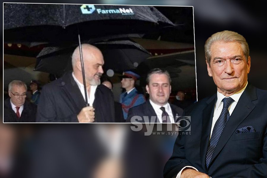 Rama holds umbrella with the logo of favorite pharmaceutical firm, Berisha: Bought from his pockets to his heels